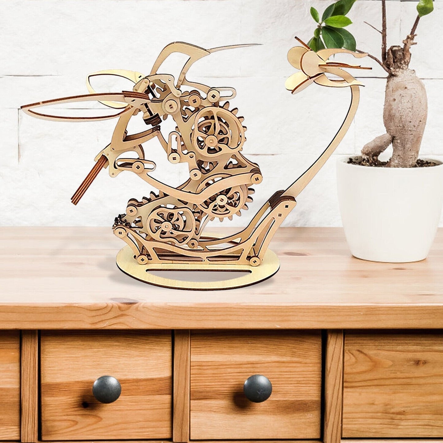 Wooden mechanical model of a sailboat on a wooden surface with a plant Diyion | Kinetic Hummingbird Sculpture - 3D Wooden Mechanical Puzzle Kit