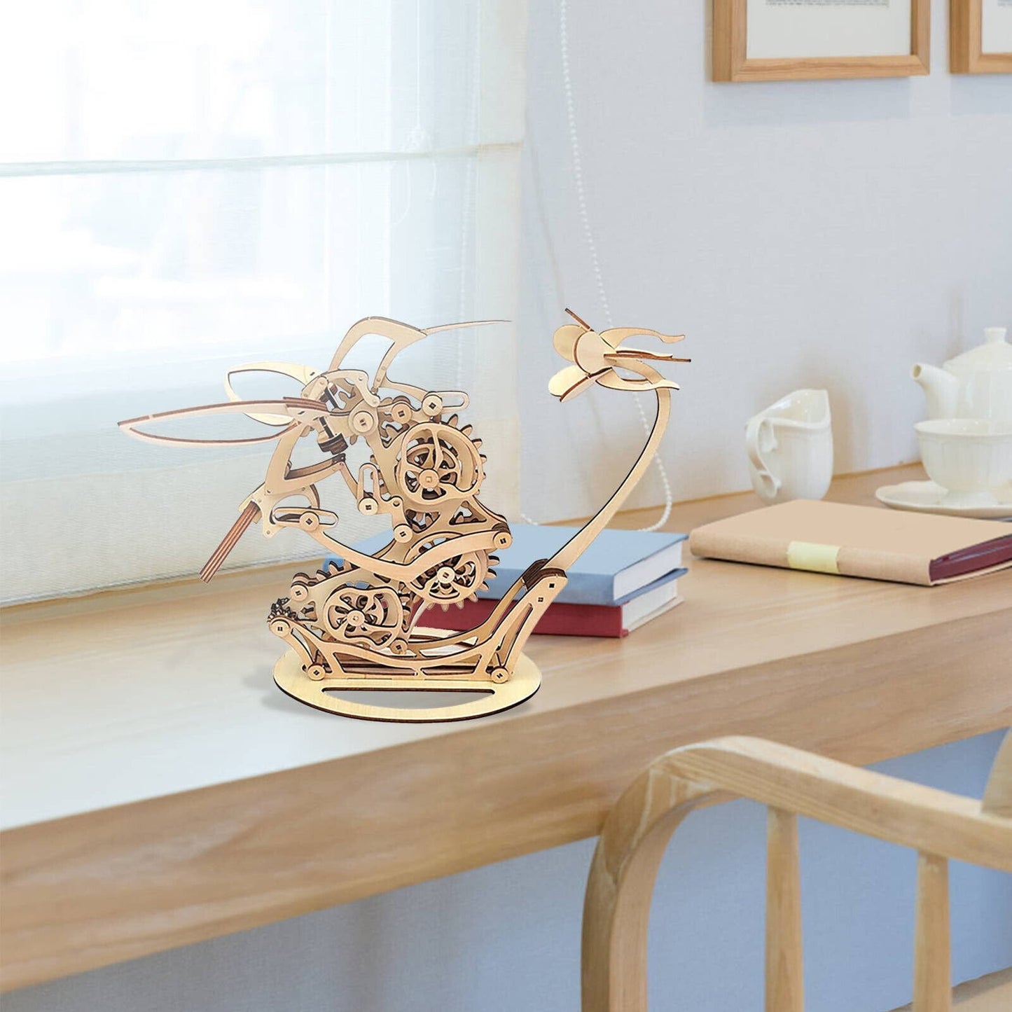 Wooden sailboat model on a desk with books and a teapot Diyion | Kinetic Hummingbird Sculpture - 3D Wooden Mechanical Puzzle Kit