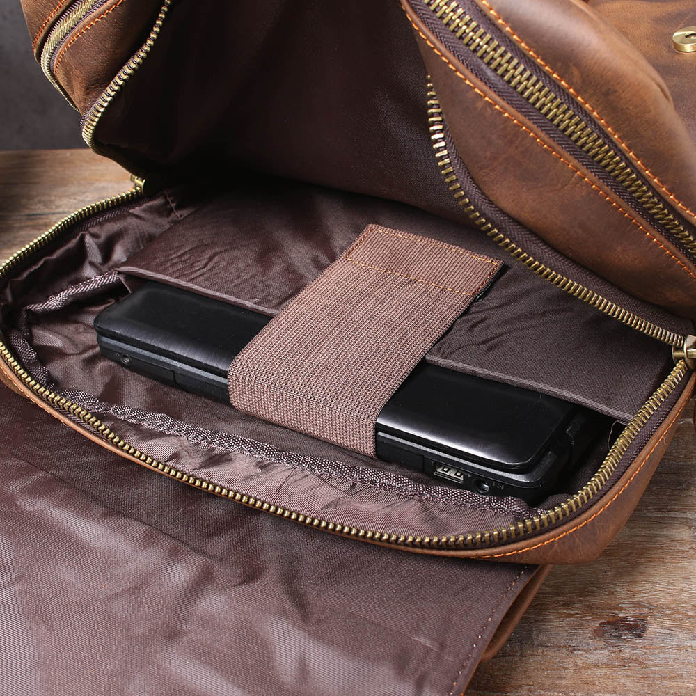 inside the brown leather rucksack: elasticated pocket holding a phone