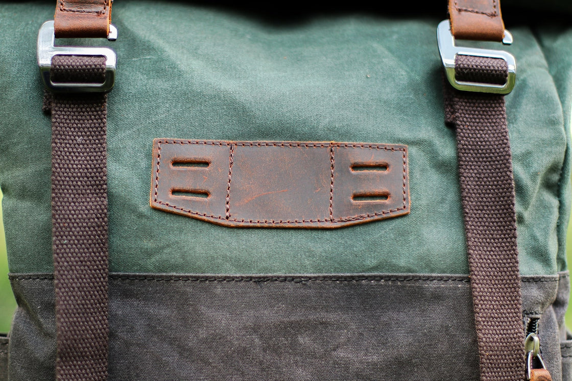 Close-up of the metal zipper and leather pull tab on the Dublin canvas daypack