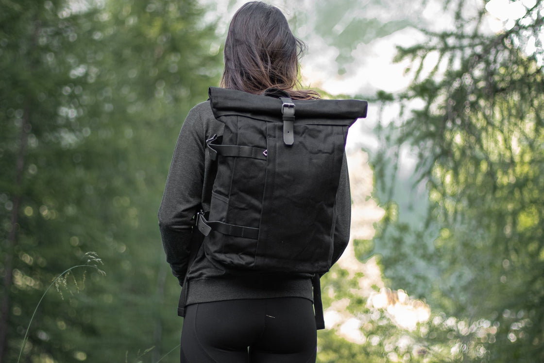 Black Gstaad commuter laptop daypack styled to store tablets and a 15-inch laptop with rolltop closure