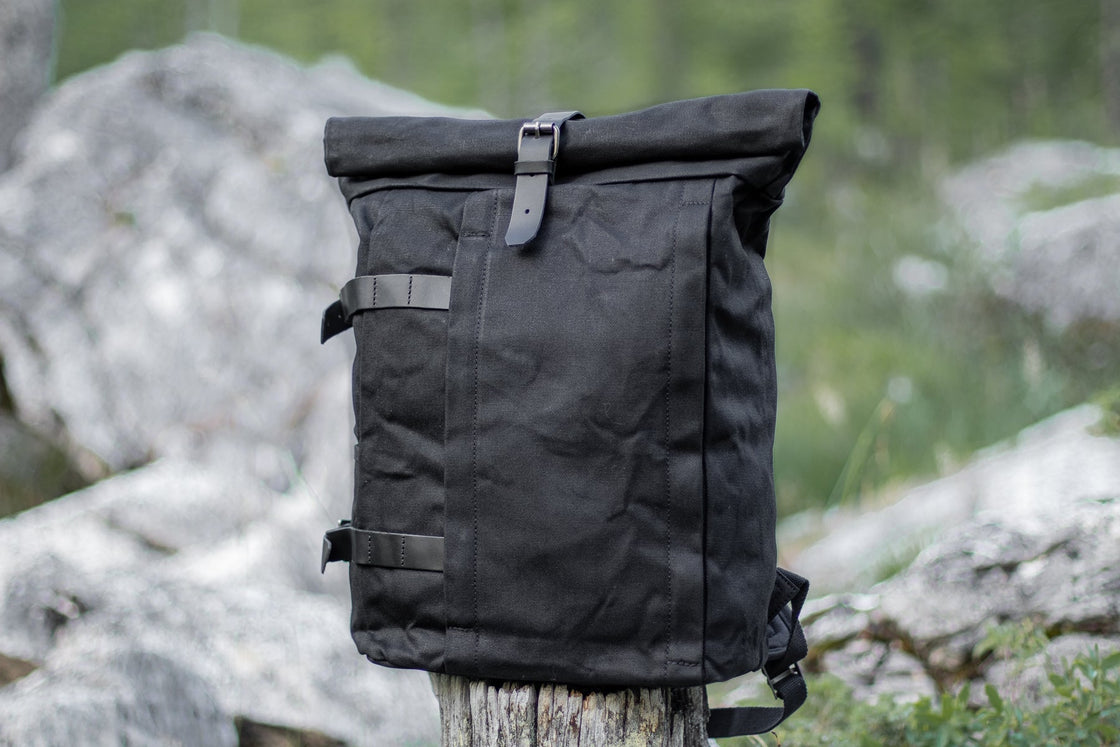 Black Gstaad waterproof biker large canvas backpack styled without a waist strap, rolltop closure