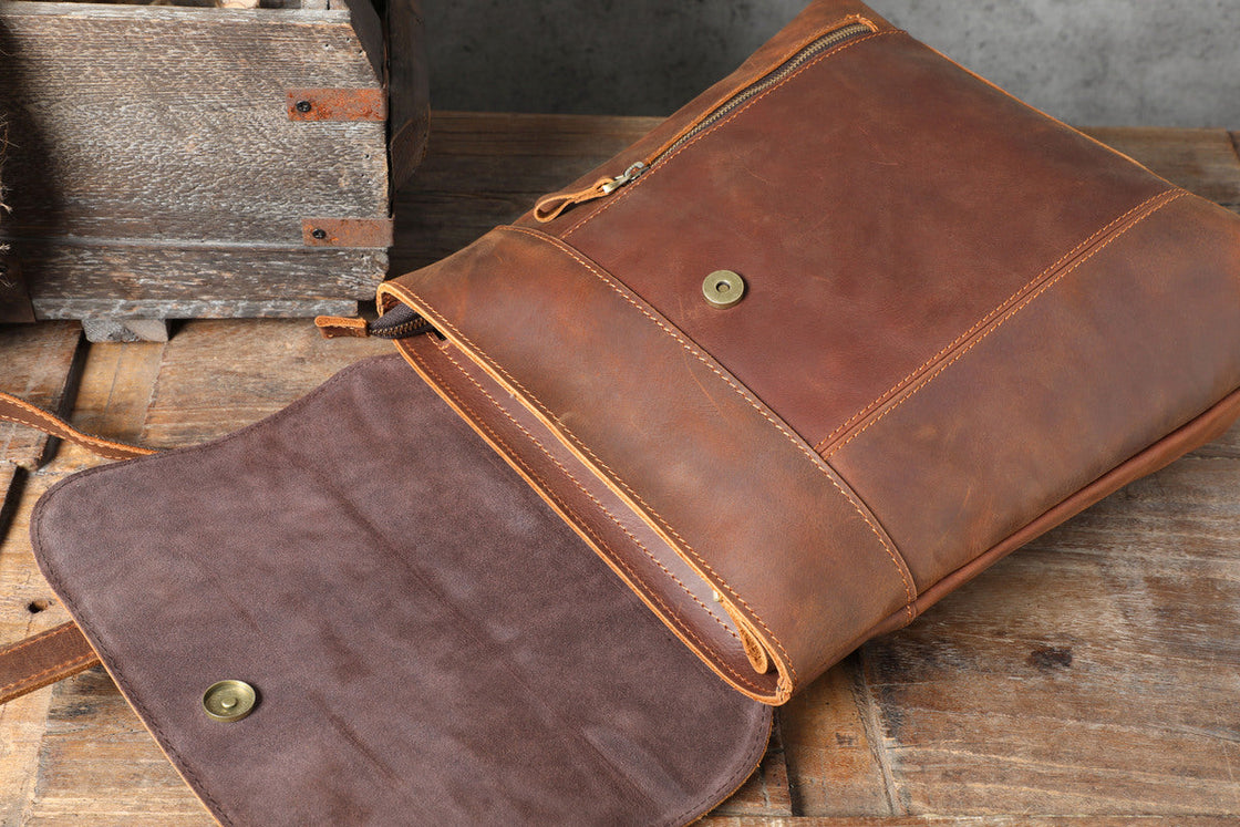 small tanned weekender leather back pack with zipper pockets