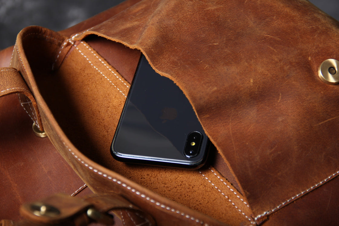 genuine leather carry on backpack with sturdy stitching and leather straps