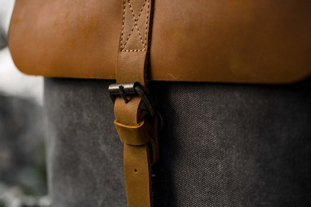 Beige Nora women's canvas backpack on a soft white background, crazy horse leather flap and minimalist design