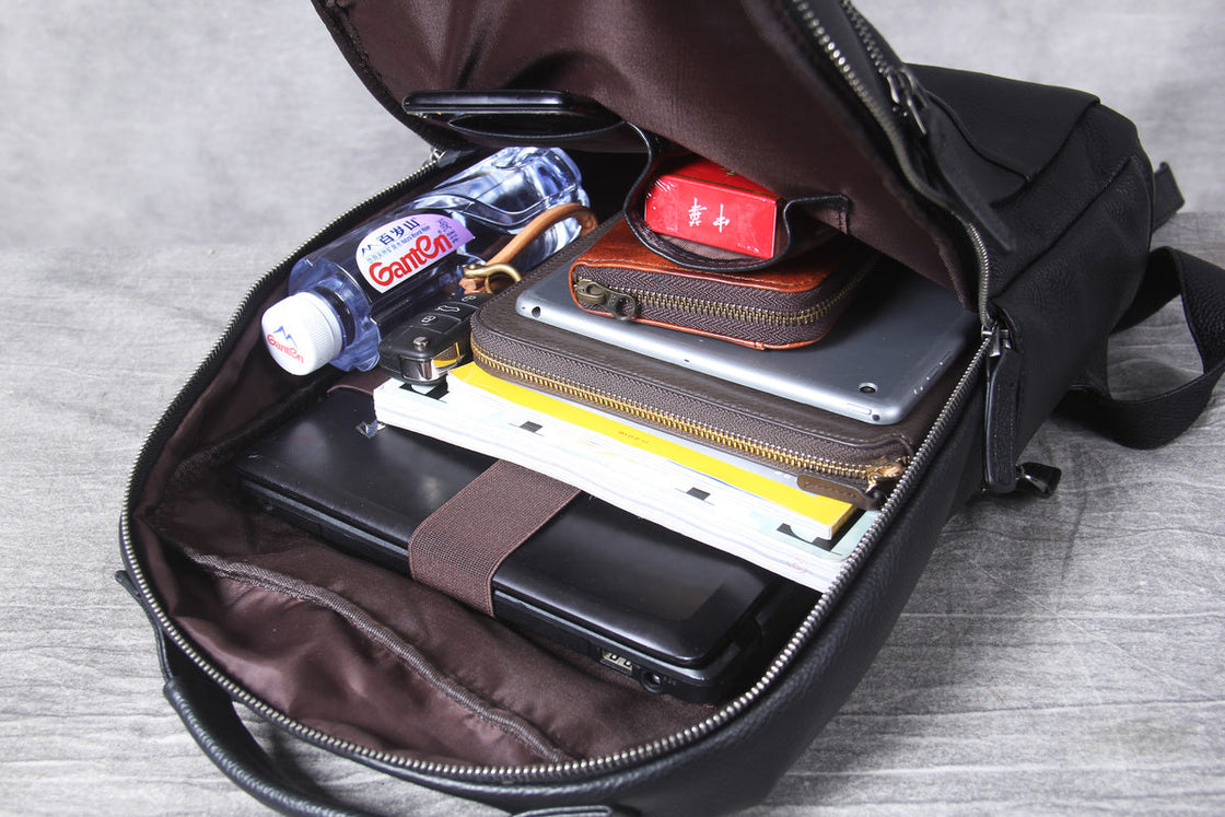 webbing adjuster and gunmetal buckle under the padded leather shoulder strap