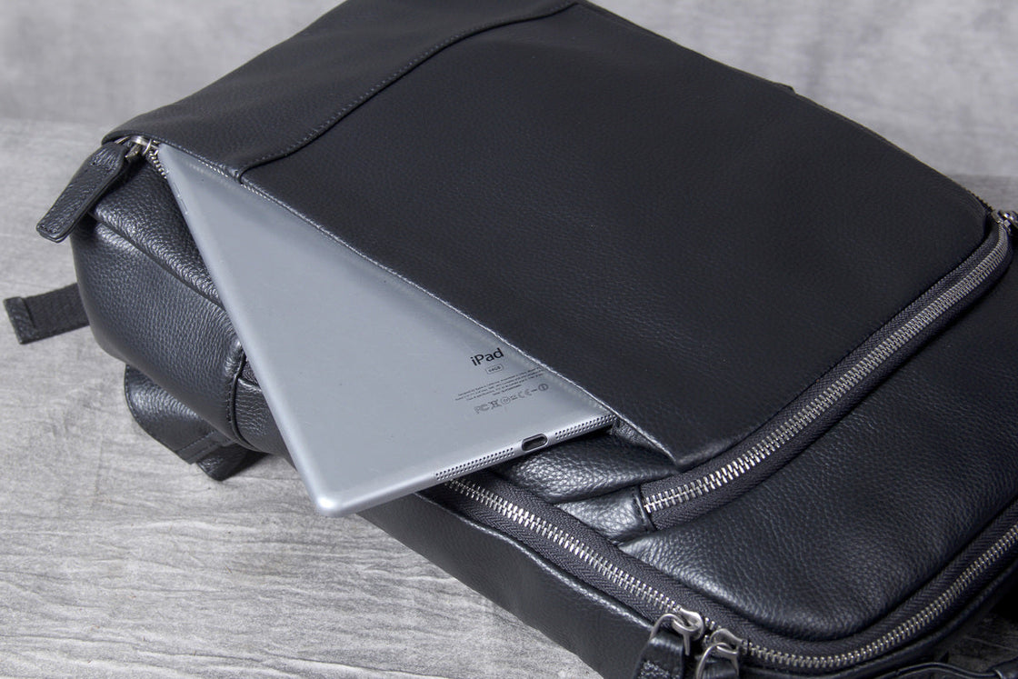 front zip pockets of the black leather laptop backpack seen from above