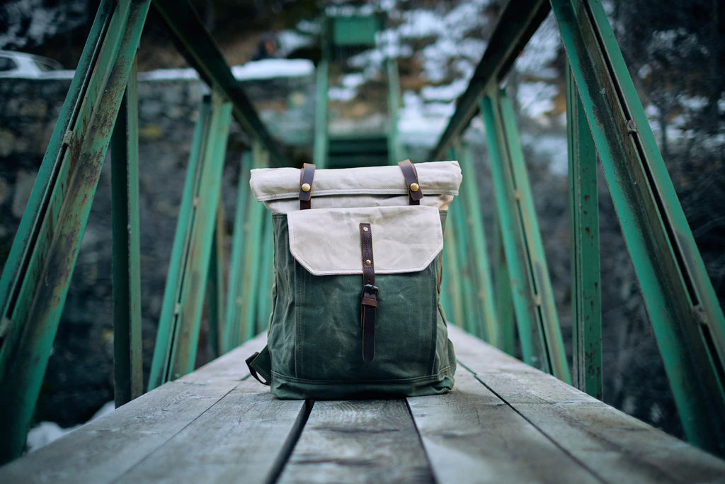 Detail of the side cargo pocket leather flap with brass snap closure on the Yukon vintage rucksack