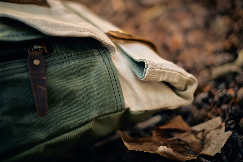 Detail of the cotton canvas shoulder strap with brass slider buckle on the Yukon vintage backpack