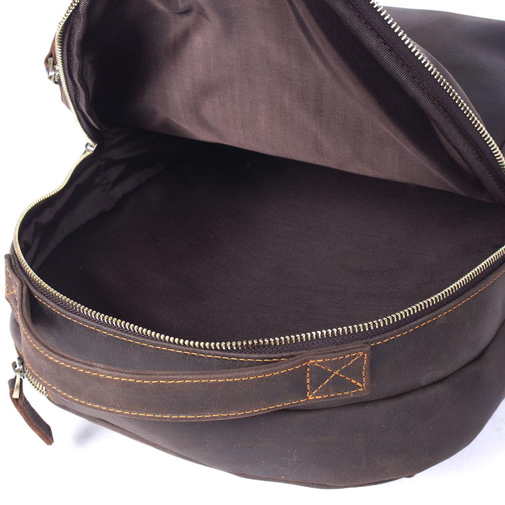 Close view of the Coda leather backpack opening, zip and interior lining