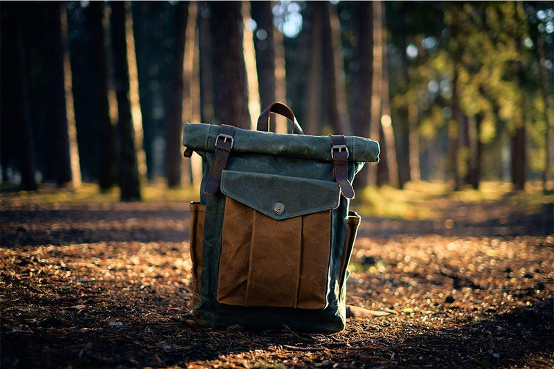 Lund waxed canvas backpack standing on a forest floor