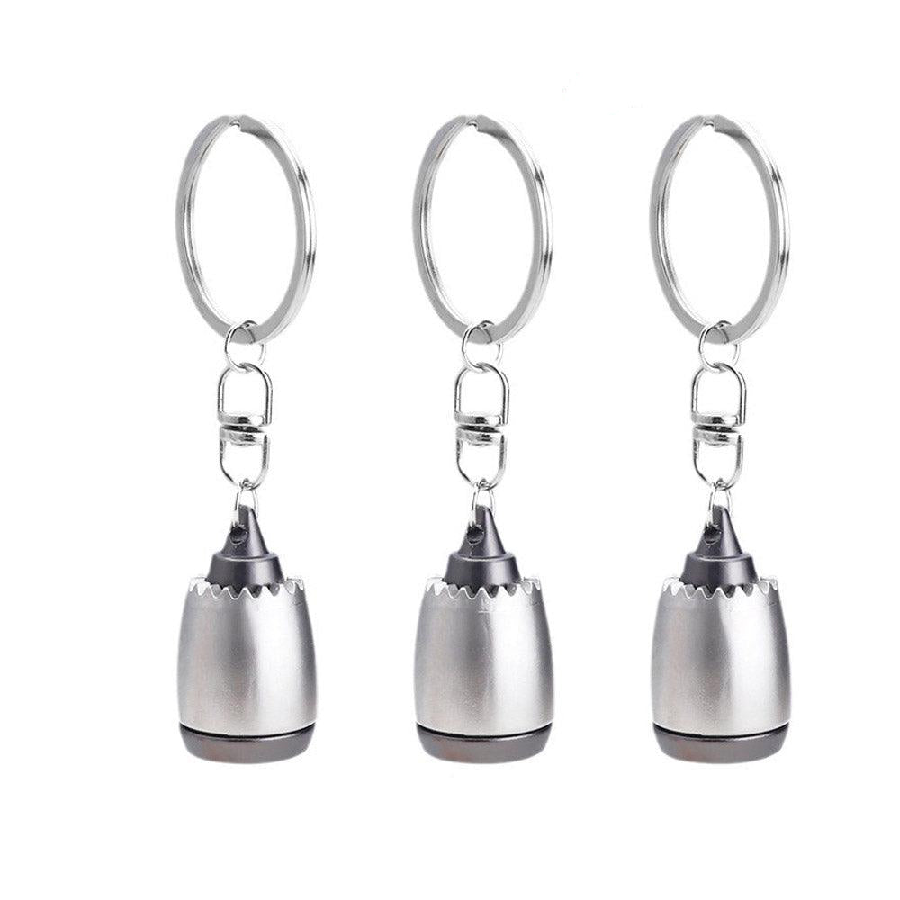 Three silver keychains with a unique design on a white background