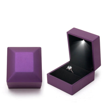 Purple jewelry box with a ring inside on LED ring box with automatic light for engagement proposals and wedding jewelry display