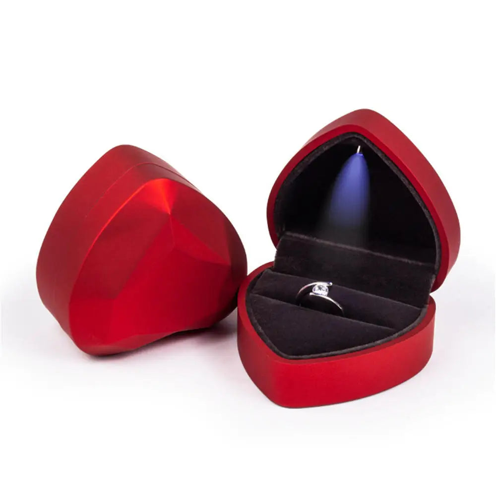 Red heart-shaped jewelry box with a ring inside LED ring box with automatic light for engagement proposals and wedding jewelry display