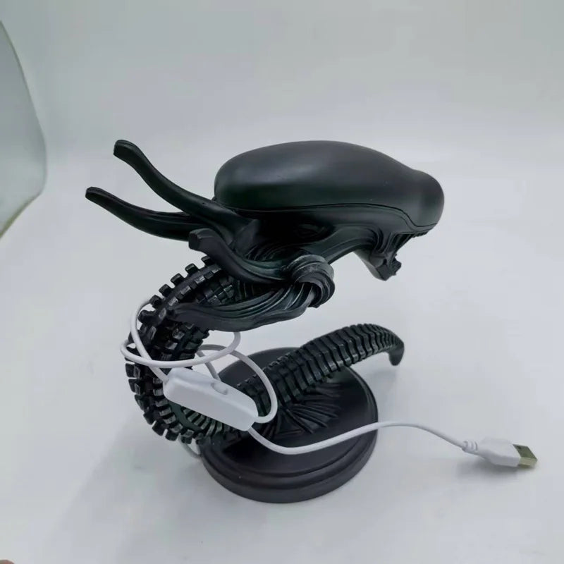 Black alien figure with a coiled cable on a white background - Unique alien creature resin lamp stand for modern home decor