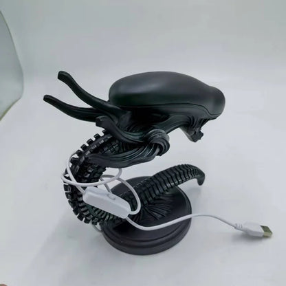 Black alien figure with a coiled cable on a white background - Unique alien creature resin lamp stand for modern home decor