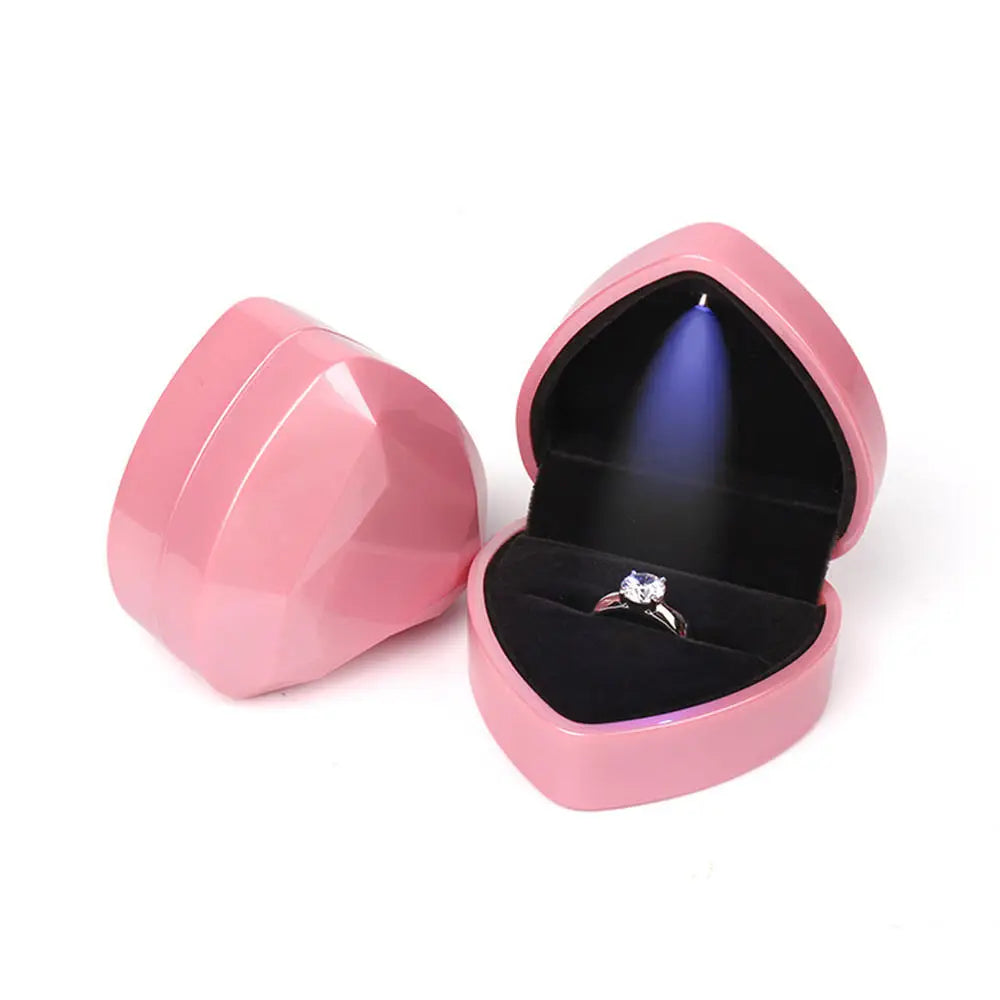 Pink heart-shaped jewelry box with a ring inside LED ring box with automatic light for engagement proposals and wedding jewelry display