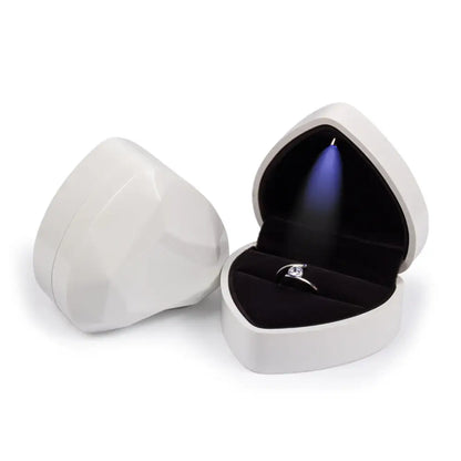 Heart-shaped jewelry box with a ring inside on a white background
