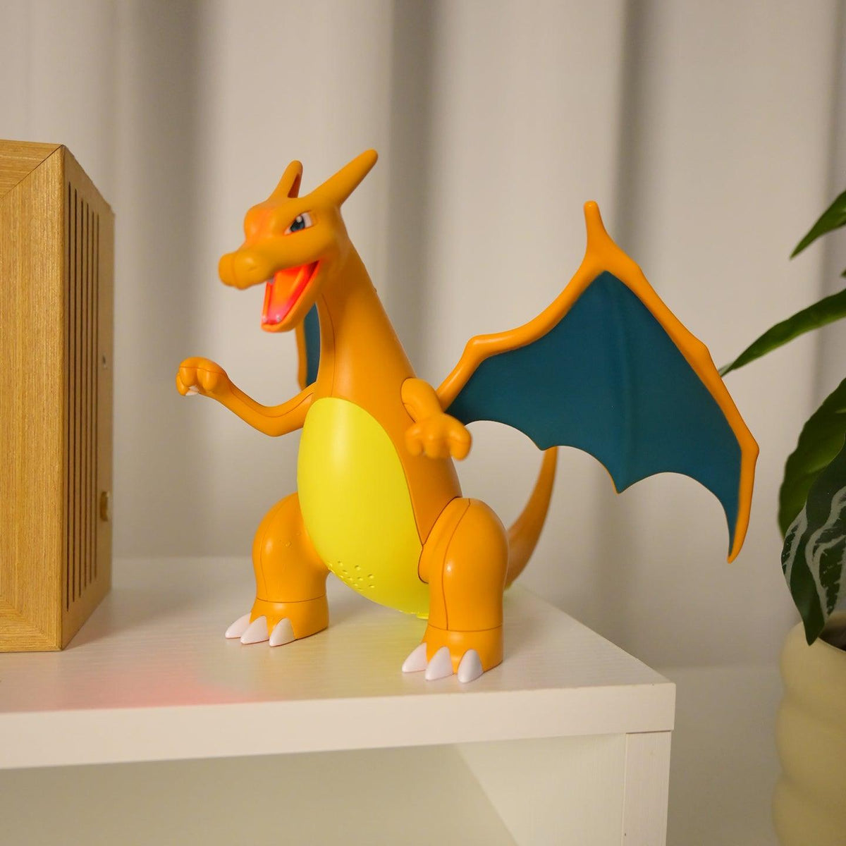 Diyion interactive Charizard toy with flashing LED tail and 5ml water spray system